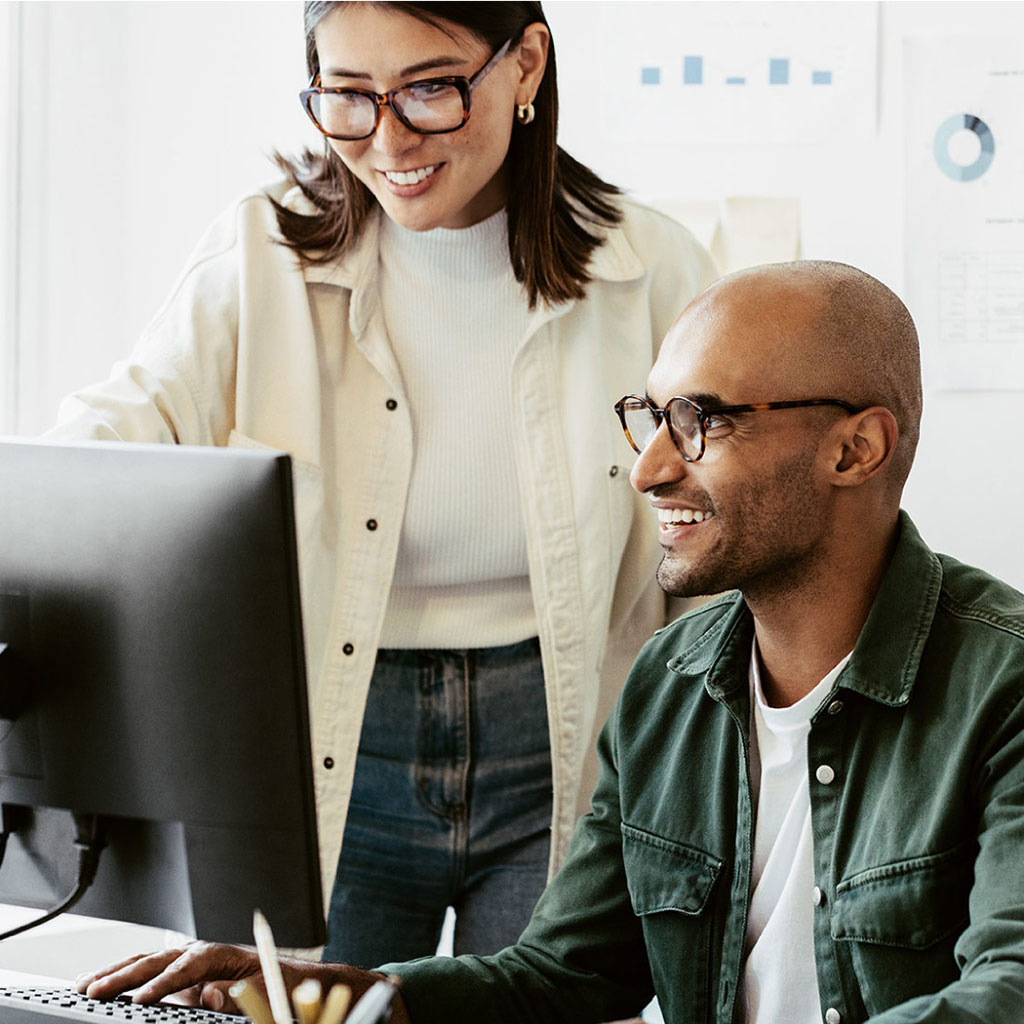 Addison Group's career page. Two people gathered around a computer.