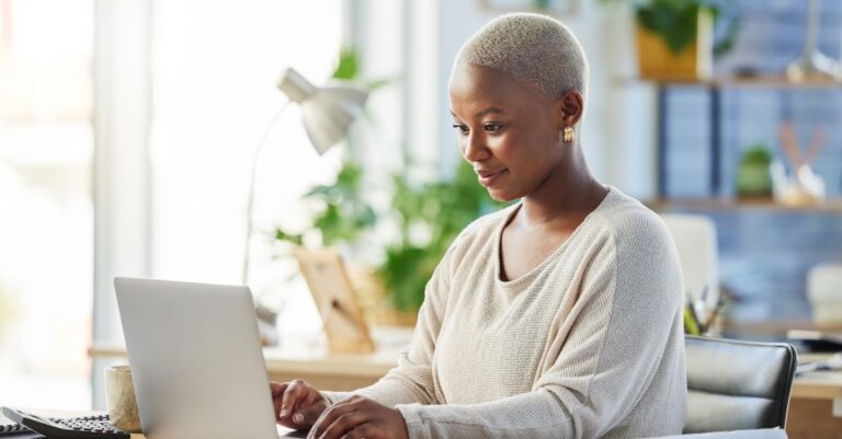 Person at computer learning about resume mistakes from Addison Group