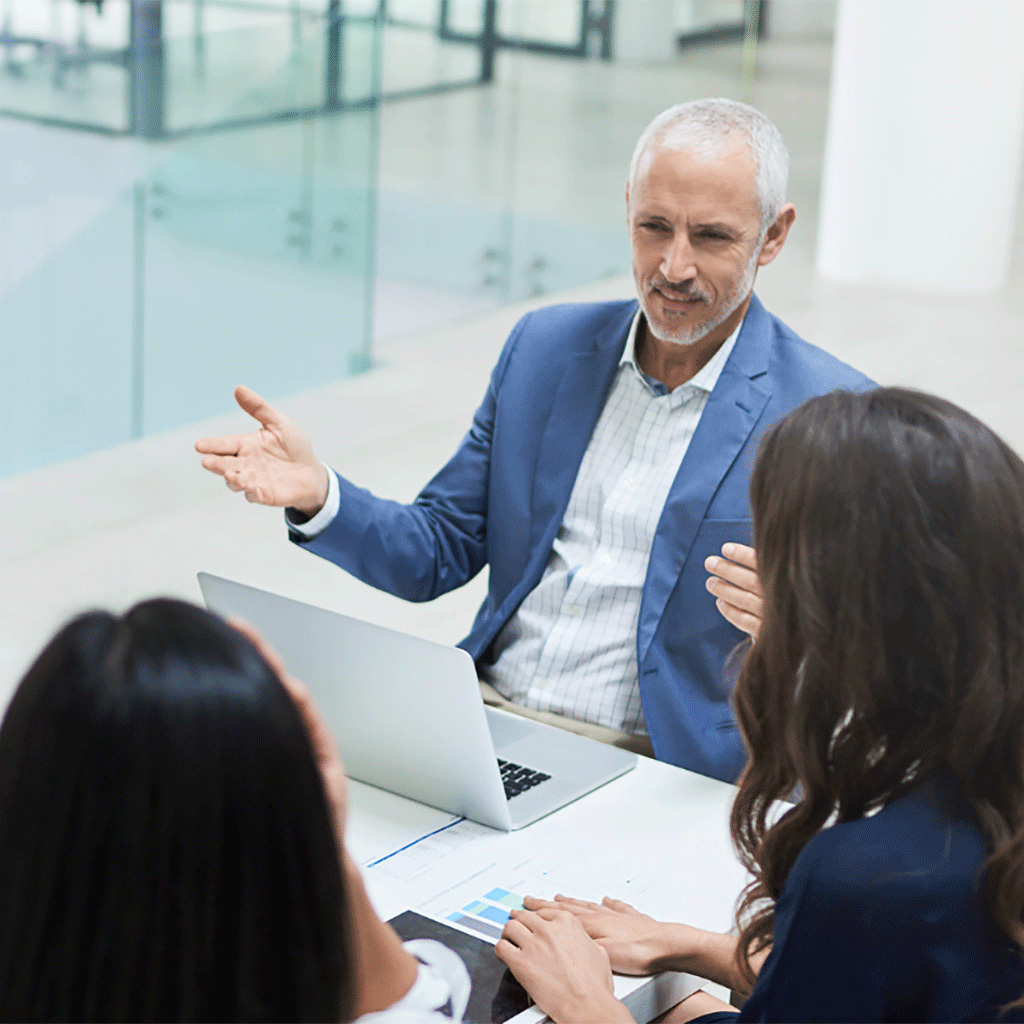 Addison Group's executive search page, featuring a man with his computer open.