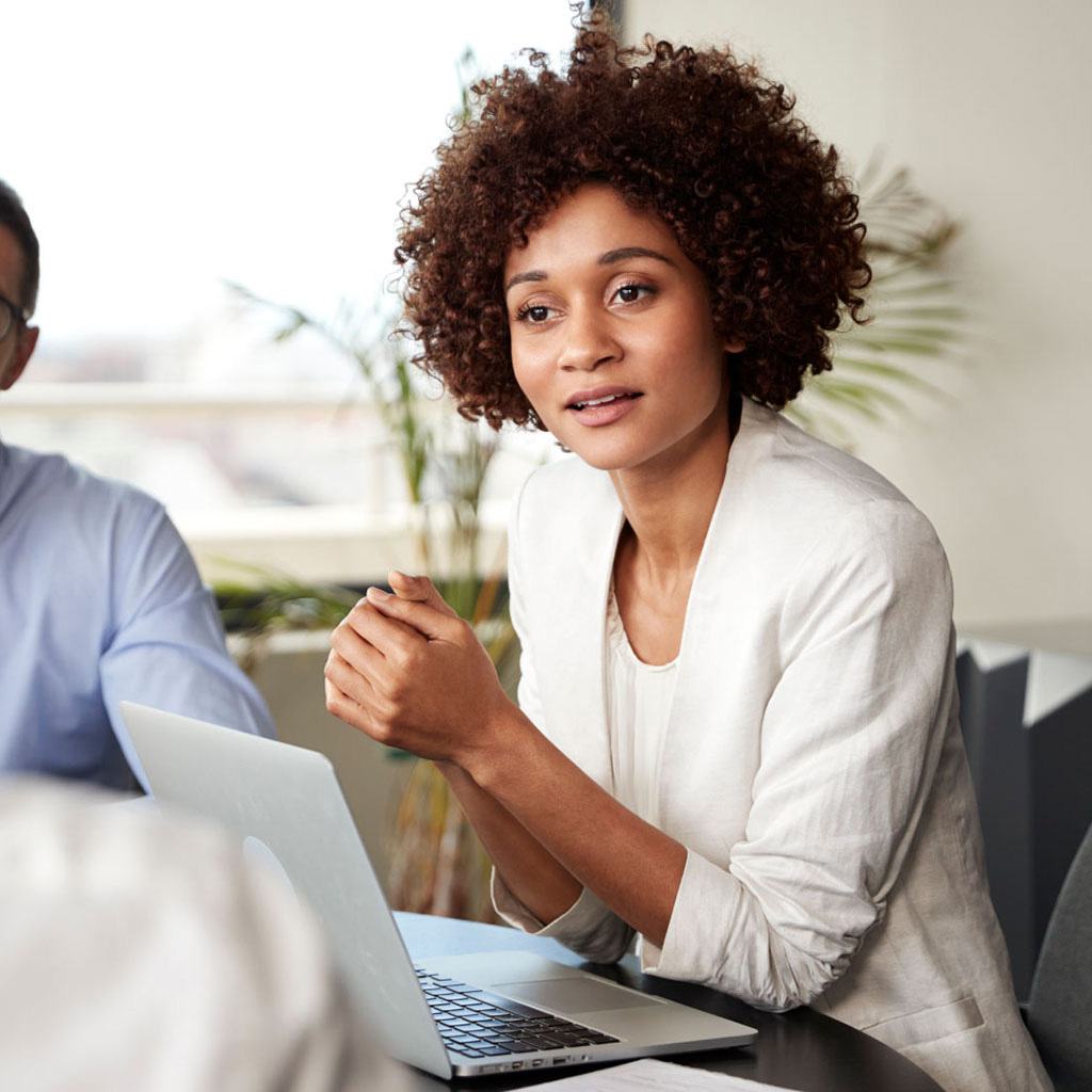 Addison Group's human resources page, showcasing a woman with her computer open.
