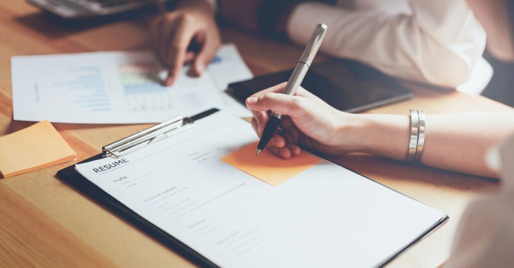 Person tailoring their resume using Addison Group's advice