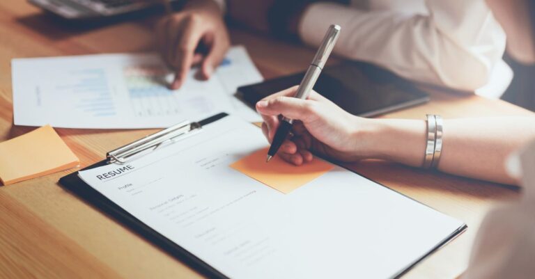 Person tailoring their resume using Addison Group's advice