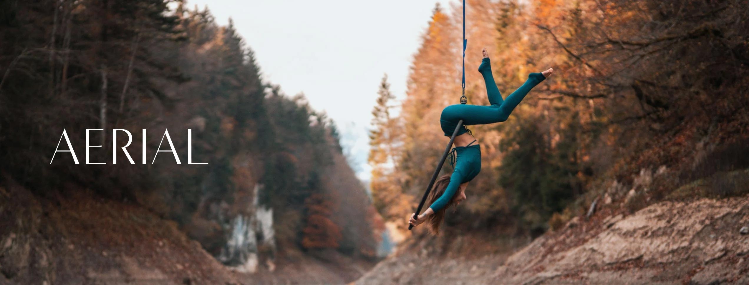 model doing aerial yoga in the woods